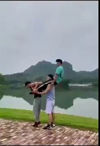 Three Chinese acrobats show their powerful core stability on the body balance maneuver. | Different China