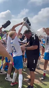 Coach Dave Hill getting a well deserved shower from his boys. Great job Boys, and Coach Dave. Now off to Denver | Dynamos Soccer Club