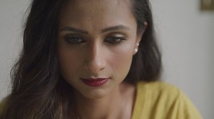 Serious Young Woman Looking Down at Her Work During the Day