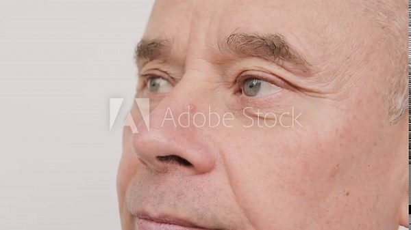 man 65 years old looks into distance, sees poorly, squints, puts on glasses, close up mature male face, myopia, Vision Correction Options, ocular health, fatigue syndrome eye pain, corneal ulcers