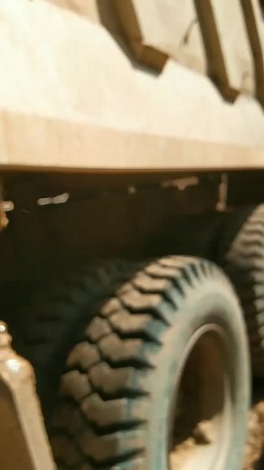 Muddy Construction Site with Orange Dump Truck
