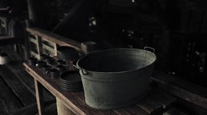A rustic wooden table with a metal bucket as a centerpiece