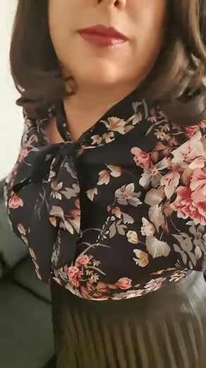 elegant crossdresser. floral silk bow blouse and pleated leather skirt