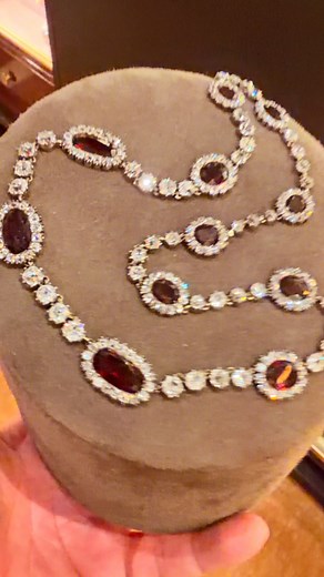 Garnet was a widely used and symbolically rich gemstone in 19th-century diamond jewelry, particularly in the Victorian era, where it appeared both as a focal stone and alongside diamonds for dramatic color contrast and artistic effect. Garnets were often employed in parures—matching sets comprising necklaces, bracelets, earrings, and brooches—either as the central stone or as accents alongside diamonds and seed pearls. The stones were typically cut as rose-cut, cabochon, or flat-cut almandine an