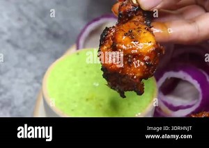 Cooking chicken tikka on a tandoori barbecue charcoal grill. Aslam Chicken, Jama Masjid, Old Delhi Street Food / Ramadan Food / Sehri /Eid 2020 Delicious pieces perfectly red.