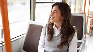 Beautiful young woman enjoying her ride on a city bus