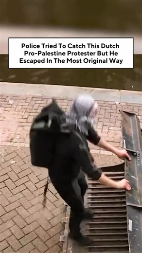 Almost on Instagram: "A Dutch pro-Palestine protester in Amsterdam, the Netherlands, jumped into a canal to escape from police who were cracking down on a student protest at the University of Amsterdam. A video by Amsterdam news outlet AT5 circulating on social media showed the protester, who was wearing a keffiyeh, trying to stop a police bulldozer from removing a barricade before a police officer tried to approach him with a shield and baton. The protester then runs away,jumps into the canal a