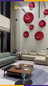 This extravagantly done, double-height lobby coupled with a refined seating area and stairway in the background is a testament to the benchmark of luxury. Enveloped with a bouquet of enticing interior solutions that include: lights, wall art, decorative pieces, and more this space has it all to treat your senses. #homeinspiration #homeinterior #homedecor #interiordesign | Housing.com