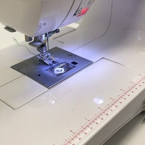 Use a Satin Stitch Foot so dense stitches can pass freely underneath the foot. Experiment on scrap fabric with different thread for various effects, then adjust stitches as desired. Use tear-away stabilizer underneath fabric to prevent dense stitches from puckering the fabric. Mark your stitching guidelines on the fabric with a removable fabric marking tool. #singersewingcompany #singersewingmachine #tipsandtricks #sewingtips #holidaysewing | Singer Sewing