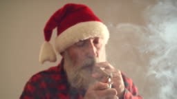 Adult mature man with gray hair and beard, wearing a hat of Santa...