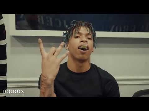 NLE Choppa throwing up gang signs while buying grills