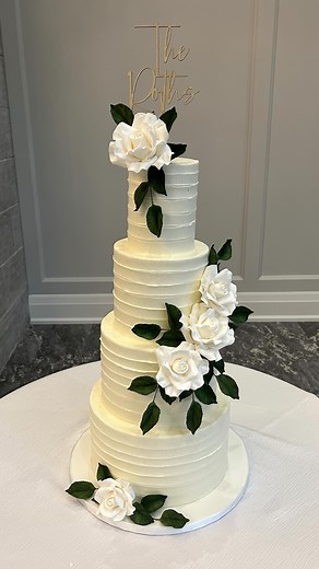 Timeless, classic, and endlessly romantic. . Layers of softly textured buttercream, delicate sugar roses, and a touch of personalization on top — a design that lets simplicity shine in the most beautiful way. . For the couple who loves understated elegance. . . . . . #designyourdreamweddingcake #handcraftedsugarflowers #weddingcake #sugarflowers #cambridgeweddingcakes #eloraweddingcakes #gtaweddingcakes #kitchenerweddingcakes | Fancy That Cake