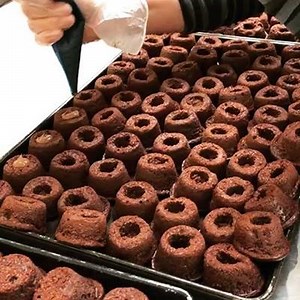 Our Pearls being filled with low cal chocolate frosting at our West London bakery. All our cakes and cookies are lovingly made by hand 🍰🍪. | Mariella's