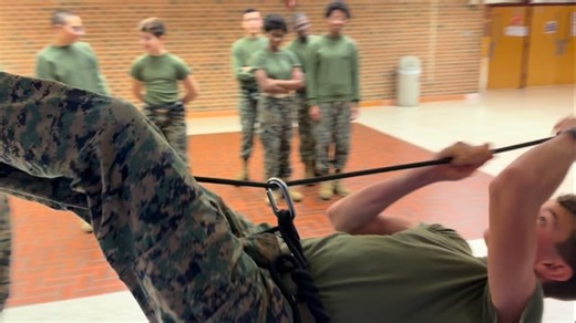 The MCJROTC Raider team practicing the 1-Rope Bridge which is a challenging obstacle during Raider competitions. The 1-rope bridge requires a team to rapidly construct a single-rope bridge across a gap (i.e., a river) using specific knots, anchors, and safety gear (like Swiss seats) to get all team members across within a time limit, testing teamwork, physical fitness, and leadership. | Mount Vernon High School Marine Corps JROTC