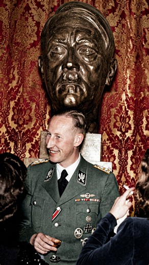 Revived Visuals on Instagram: "This photograph, taken on May 26, 1942, captures one of the final moments of Reinhard Heydrich’s life. Heydrich, the Acting Reich Protector of Bohemia and Moravia, is pictured here at the Wallenstein Palace in Prague. He is attending a concert featuring the music of his father, composer Bruno Heydrich. The image shows him relaxed, smiling, and holding a drink, basking in the “cultural” atmosphere of the occupation. At this moment, Heydrich was at the peak of his po