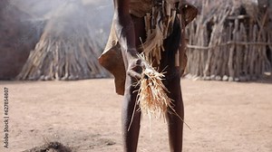 Close-up of a Local man from Damara tribe making a fire in slow motion. Traditional life in Damaraland in Damara Living Museum. High quality FullHD footage.
