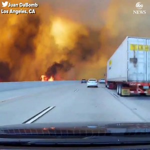 Video taken Friday shows huge wildfire surrounding Los Angeles freeway; more than 700 homes have since been ordered evacuated. http://abcn.ws/2wtybru | ABC News