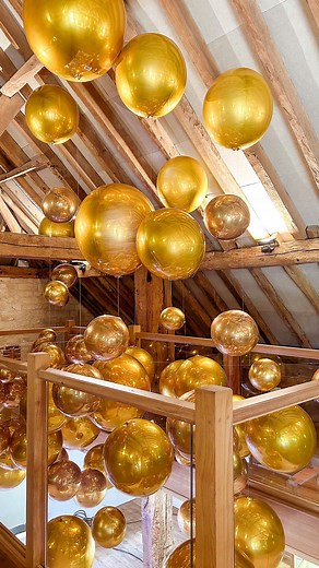 Get ready to be dazzled! ✨ Our gold chrome orb balloons are elegantly suspended from the ceiling, creating a stunning focal point that will leave your guests in awe. Perfect for adding a touch of glamour to any event! 🎈🌟 | Bubblegum Balloons