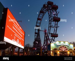 Wien, Vienna: information video wall with text that Prater is closed (in English), Ferris Wheel at Prater closed due to corona virus (COVID-19), in 02 Stock Photo - Alamy