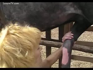 Blonde slut milks her horses cock until it squirts
