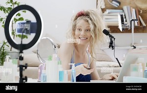 Blonde smiling woman influencer blogger recording a video tutorial on smartphone camera test the equipment for showing how to apply makeup. Female vlo Stock Photo - Alamy