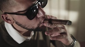 clip-1015337686-young-handsome-man-smoking-cigar-luxury-hotel