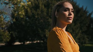 Stylish young woman with arms crossed outdoors. | Free Stock Video Footage