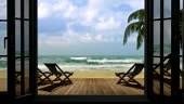 View through a window on the sea, palm trees near the hotel