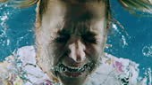 Super slow motion underwater shot of a mid adult woman screaming...