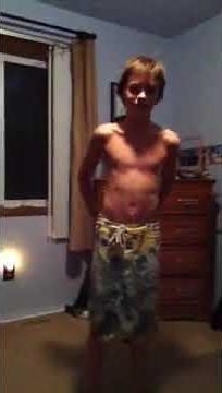 Guy pulling swimsuit off