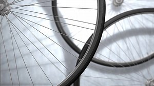 Close-up bicycle wheel spinning, shop, background..