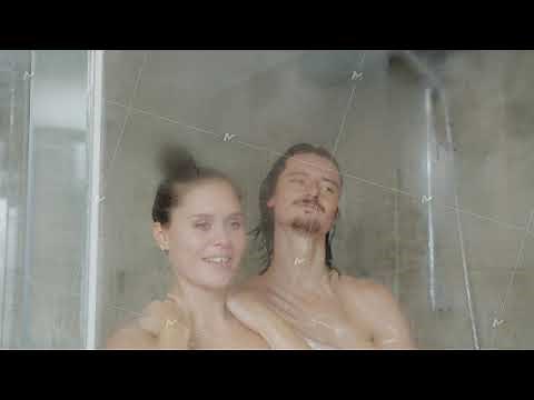 Slow motion of man and woman taking shower together washing bodies with soap