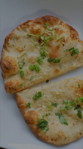 Soft and fluffy Cheese Naan - sooo good you can eat it all by itself!! -3 cups or 375g all purpose flour -7g sachet or 2 teaspoons active dry yeast -1 teaspoon salt -1 teaspoon caster sugar -handful chopped coriander leaves -1/3 cup greek yoghurt or plain natural yoghurt, at room temperature -2-3 tablespoons coconut oil or ghee -3/4 cup warm water -1.25 cups grated mature cheddar -3 tablespoon melted butter for brushing, optional Full recipe on our website - simply search 🔍 “Cheese Naan” on www