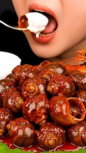 8.7K views · 25 reactions | Snails, Squid & Lobster Feast 撚咽 | Extreme Seafood ASMR . .  Caption . Glossy snails, chewy squid, juicy fish, and rich lobster all in one plate 襤 Slow bites, deep flavors, and pure ASMR satisfaction. Watch till the end with sound ON  . . #SeafoodASMR #FoodASMR #MukbangASMR #SatisfyingFood | Asmr Mukbang | Facebook