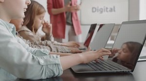 Side View Cropped Elementary Aged Students Sitting Table Classroom Using