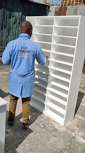 Add a glam storage solution to your entryway or closet with this modern shoe rack from BACH furniture. Made from white solid wood and acrylic, this shoe storage solution features scrolling cut-out designs for an airy, luxe appearance. We love that its open-shelf design allows for quick and easy access to your favorite footwear while keeping your space clutter-free. Plus, there's room up top for a key tray or decorative photos. | BACH Furniture