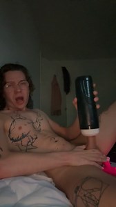 Horny femboy jerks off in bed using flashlight