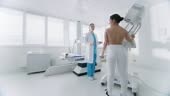 In the Hospital, Mammography Technologist / Doctor adjusts Mammogram...
