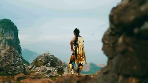 a female warrior in golden armor was practicing martial arts on a mountain