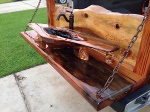 Wasted Time Sinker cypress burl sink. Sink is completely functional and water-tight. The sink, backsplash, and counter are all sinker cypress from the Atchafalaya Basin in Louisiana. These logs were cut down in the early to mid-1800's. The side posts and the stand are all from the same house on Elysian Fields in New Orleans destroyed by Katrina. The bowl is made from a burl where a cypress branch broke off and the tree healed itself over the break, creating a burl. The base, backsplash, and sink
