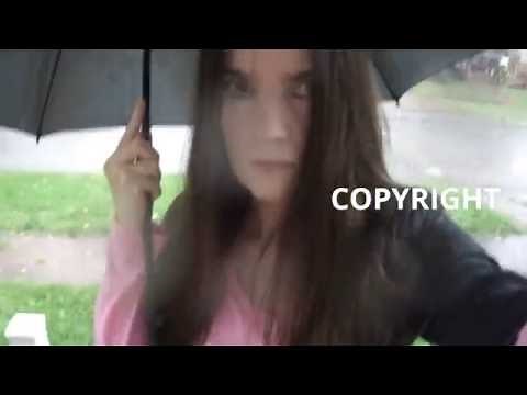 Woman Walking In Rain Heavy Downpour Carrying Umbrella walks holding the umbrella