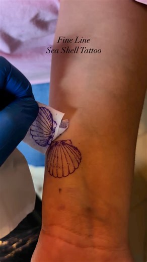 Ink Stain Tattoos on Instagram: "Delicate as a whisper, a fine line sea shell tattoo symbolizes protection, resilience, and connection to the sea. The sea shell represents a journey through life, weathered by waves yet retaining its beauty. It serves as a reminder to embrace change and cherish the small treasures along the way. Carrying a sea shell with you – even in ink – is a way to keep the calming, grounding energy of the ocean close, making all the difference in your life’s journey. Do like