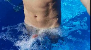 German Guy in the swimming pool enjoying the Waterfall