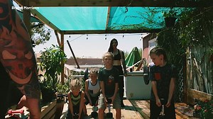 Schoolboys lift weights with bodybuilding parents