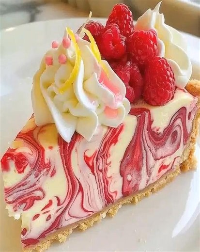 1.4K views | Creamy, zesty, and bursting with raspberry swirls — this cheesecake is a showstopper for any occasion. No fuss, all flavor, and pure indulgence in every bite!  Tag someone who needs to try this! #RaspberryCheesecake #CheesecakeSlice #EasyDesserts #BerryLovers | Fen Recipes | Facebook