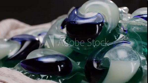 Laundry capsules for washing machine close-up. capsule contains concentrated liquid detergent and powdered ingredients. Capsules for dirty clothes. Cleaning concept.