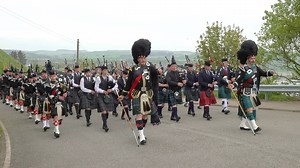 Drum Majors lead the parade as it marched up Black Hill above Stonehaven in Aberdeenshire, Scotland. The parade was marching to the summit of Black Hill for the Stonehaven & District War Memorial Commemoration and Rededication Ceremony (1923-2023) on Saturday 20th May 2023. The massed bands were led by Drum Majors Robb Cumming and Rob Brownfield and the bands taking part included members of Newtonhill Pipeband, Lonach Pipe Band, Banchory Pipe Band, Howe O' The Mearns Pipe Band, Granite City Pipe