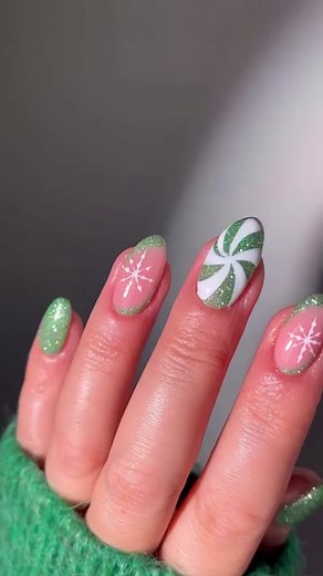 Some sparkling peppermint swirls and snowflakes to make your season bright. ✨💚 Nails by: @gelalicious —— #nailpro #nailpromagazine #nailpromedia #nailart #naildesign #nailsofinstagram #nailinspo #holidaynails #christmasnails #winternails #snowflakenails #peppermintnails #glitternails #reflectiveglitternails #greennails #grinchnails | Nailpro