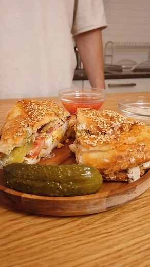 Boureka sandwich, with all the fixings! We recommend adding a hard boiled egg🥚 tomatoes🍅, Israeli pickles 🥒, Tahini - and S’chug🔥. With a side of mashed tomato and tahini of course. Alternatively, you can add fried eggplant to make a Sabich. Or maybe a Shakshuka boureka sandwich? What’s in YOUR boureka? #boureka #israel #israelifood | Jewlish