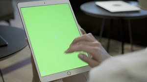 Woman swiping fingers on a tablet - Free Stock Video